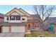 Charming two-story home featuring a stone-accented facade, two-car garage, and well-manicured lawn at 22388 Quail Run Dr, Parker, CO 80138