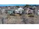 An elevated view shows neighboring homes surrounded by mature trees, hills, and partial fencing at 22388 Quail Run Dr, Parker, CO 80138