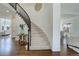Bright foyer showcasing a curved staircase with elegant black railings and beautiful hardwood floors at 22388 Quail Run Dr, Parker, CO 80138