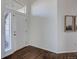 Inviting foyer with gleaming hardwood floors, bright white walls, and natural light from large windows at 22388 Quail Run Dr, Parker, CO 80138