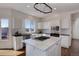 Bright kitchen features white cabinets, a center island with a gas range, and stainless steel appliances at 22388 Quail Run Dr, Parker, CO 80138