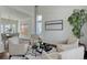 Bright and airy living room featuring comfortable seating and seamless access to dining area at 22388 Quail Run Dr, Parker, CO 80138