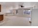 Large living room with carpet floors, fan and recessed lighting next to the kitchenette at 22388 Quail Run Dr, Parker, CO 80138