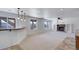Spacious living room with carpet, windows, a wet bar, and a fireplace with built-in shelving at 22388 Quail Run Dr, Parker, CO 80138
