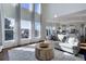 Bright living room with hardwood floors, soaring windows, and seamless flow into kitchen area at 22388 Quail Run Dr, Parker, CO 80138