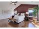Spacious primary bedroom featuring hardwood floors, large windows, and a stylish accent wall at 22388 Quail Run Dr, Parker, CO 80138