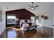Primary bedroom with a vaulted ceiling, accent wall, and hardwood floors, offering a serene retreat at 22388 Quail Run Dr, Parker, CO 80138