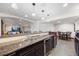 Finished basement bar boasts granite counters, wine fridge, and seating area at 3431 Fantasy Pl, Castle Rock, CO 80109