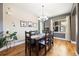 Bright dining area with a rustic wood table, decorative lighting, and plenty of natural light from a large window at 3431 Fantasy Pl, Castle Rock, CO 80109