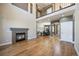 Open-concept living room with a fireplace, hardwood floors, and an adjoining dining area, ideal for entertaining guests at 3431 Fantasy Pl, Castle Rock, CO 80109