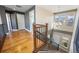 Staircase with wooden railings and a view of a chandelier and an open doorway at 3431 Fantasy Pl, Castle Rock, CO 80109