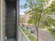Balcony view with green trees, street views, and a building in the background at 1333 Elati St # 1, Denver, CO 80204