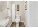Modern powder room with a sleek sink, toilet, and minimalist decor at 1333 Elati St # 1, Denver, CO 80204