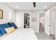 Bedroom with a walk in closet, a bed with blue decorative pillows, and a gray carpet at 1333 Elati St # 1, Denver, CO 80204
