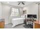 Cozy bedroom featuring neutral tones, a comfortable bed, and a window offering natural light at 1333 Elati St # 1, Denver, CO 80204