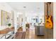 Inviting entryway with hardwood floors, a small table, a guitar, and a view into the living room at 1333 Elati St # 1, Denver, CO 80204