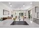 Open-concept view of the kitchen with island, flowing into the modern living room at 1333 Elati St # 1, Denver, CO 80204