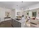 Open-concept kitchen featuring an island with views of the living room and fireplace at 1333 Elati St # 1, Denver, CO 80204