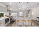 Modern kitchen with stainless steel appliances, island with seating, and gray cabinets at 1333 Elati St # 1, Denver, CO 80204