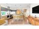 Modern kitchen with stainless steel appliances, island with seating, and wood and gray cabinetry at 1333 Elati St # 1, Denver, CO 80204
