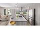 Open-concept kitchen with modern appliances and an island adjacent to the living area at 1333 Elati St # 1, Denver, CO 80204