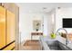 Modern kitchen area with stainless steel sink, island with seating, and a unique yellow refrigerator at 1333 Elati St # 1, Denver, CO 80204