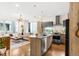 Stylish living room with an island kitchen, modern appliances, and large windows overlooking the neighborhood at 1333 Elati St # 1, Denver, CO 80204