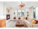 Modern living room with a fireplace, comfortable seating, and a large window overlooking the outside at 1333 Elati St # 1, Denver, CO 80204