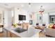 Open floor plan with a kitchen island, a stylish living area with modern furniture, and a fireplace at 1333 Elati St # 1, Denver, CO 80204