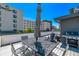 Rooftop deck featuring a dining table, seating area, and views of the surrounding buildings at 1333 Elati St # 1, Denver, CO 80204