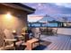 Relaxing rooftop deck with Adirondack chairs, tables, and a cozy outdoor ambiance at 1333 Elati St # 1, Denver, CO 80204