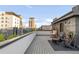 City rooftop deck with skyline views, lounge chairs, and an outdoor swing at 1333 Elati St # 1, Denver, CO 80204