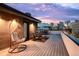 Inviting rooftop deck with comfortable seating and a beautiful city view at sunset at 1333 Elati St # 1, Denver, CO 80204