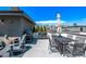 Rooftop deck with outdoor dining, lounge chairs, and a beautiful city view at 1333 Elati St # 1, Denver, CO 80204