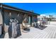 Relaxing rooftop deck with comfortable seating, a swing chair, and a grill at 1333 Elati St # 1, Denver, CO 80204