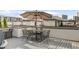 Relaxing rooftop deck with an outdoor dining set under an umbrella at 1333 Elati St # 1, Denver, CO 80204