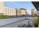 City rooftop deck with skyline view, gray seating, a swing chair and plants at 1333 Elati St # 1, Denver, CO 80204