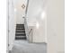 Bright staircase with gray carpet, metal railings, white walls, and modern lighting fixtures at 1333 Elati St # 1, Denver, CO 80204