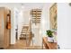 Hallway featuring a modern staircase with wooden steps and metal railings at 1333 Elati St # 1, Denver, CO 80204