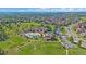 Aerial view showcases a community with a pool, clubhouse, and green spaces, nestled amongst suburban homes at 21392 E Stroll Ave, Parker, CO 80138