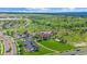 Aerial view showcases the community pool, playground, and green spaces in a desirable neighborhood at 21392 E Stroll Ave, Parker, CO 80138