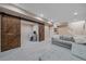 Spacious finished basement with an office area, sliding barn doors, and comfortable seating at 21392 E Stroll Ave, Parker, CO 80138