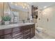 Elegant bathroom with a double vanity, modern fixtures, and a glass-enclosed shower at 21392 E Stroll Ave, Parker, CO 80138