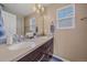 Bright bathroom with double sinks, a large mirror, and stylish fixtures at 21392 E Stroll Ave, Parker, CO 80138