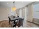 Dining area with natural light, modern chandelier, and access to the outdoor patio at 21392 E Stroll Ave, Parker, CO 80138