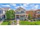 An inviting two-story home with a lovely front yard and a charming, covered front porch at 21392 E Stroll Ave, Parker, CO 80138