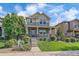 Charming two-story home featuring a welcoming front porch and beautifully landscaped front yard at 21392 E Stroll Ave, Parker, CO 80138