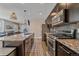 Modern kitchen with stainless steel appliances, a granite-topped island, and sleek cabinetry at 21392 E Stroll Ave, Parker, CO 80138