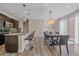 Open concept living area with a dining space, featuring modern lighting and a staircase at 21392 E Stroll Ave, Parker, CO 80138