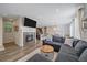 Spacious living room with a fireplace, modern decor, and seamless flow to the kitchen and dining areas at 21392 E Stroll Ave, Parker, CO 80138